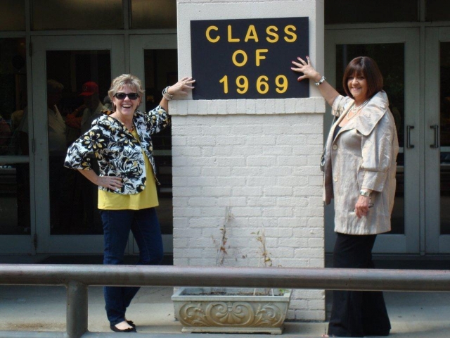 Carolyn House Fohl and Margie Mays Lester standing in front of JHS